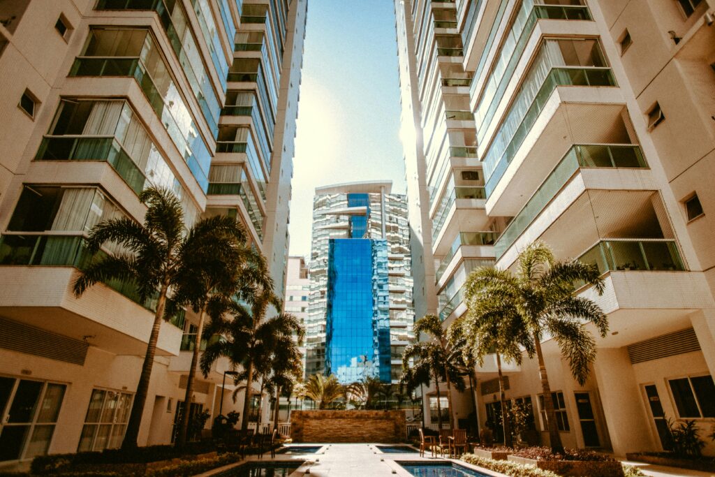 View of modern urban skyscrapers with palm trees, showcasing contemporary architecture.